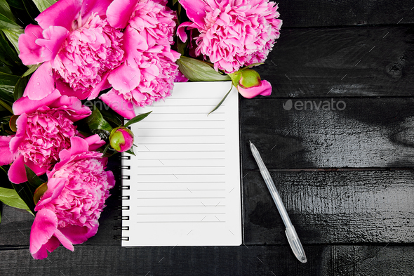 Beautiful pink peony flowers on black background with note - Stock Photo - Images
