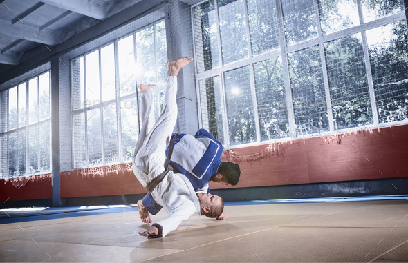 Two judo fighters showing technical skill while practicing martial arts in a fight club Stock Photo by master1305
