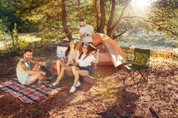 Party, camping of men and women group at forest. They relaxing Stock Photo by master1305