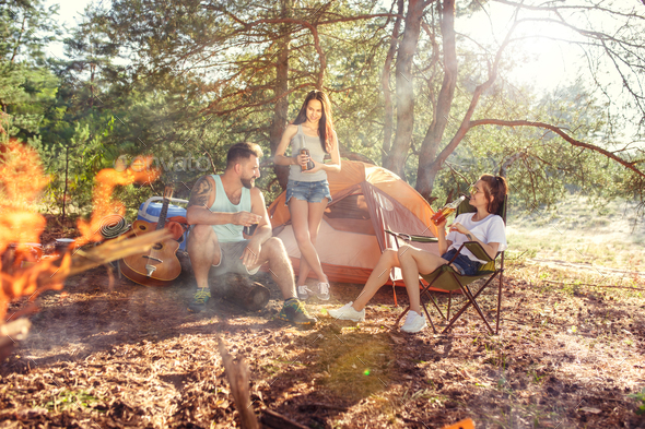 Party, camping of men and women group at forest. They relaxing Stock Photo by master1305