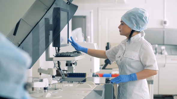 Female Lab Expert Is Managing Automatic Pharmaceutical Equipment, Stock ...