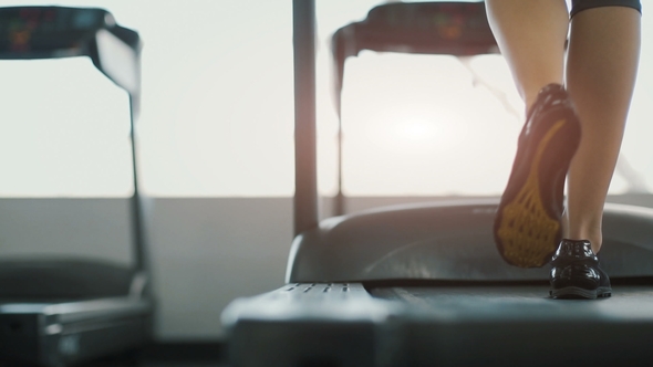 Fit Girl Running in Gym