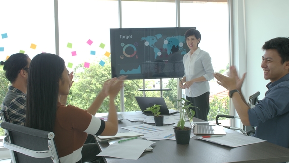 Attractive Young Business Woman Making Presentation in the Conference Room alt