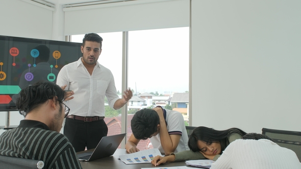 Bored Colleagues Attending Meeting In Conference Room