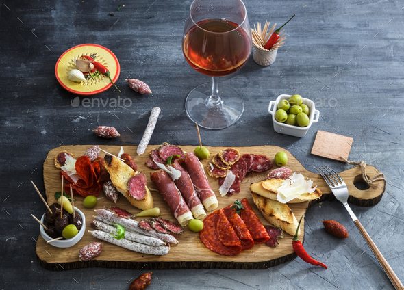 Typical spanish tapas concept. include variety slices jamon, chorizo, salami. Copyspace. Stock Photo by fazeful