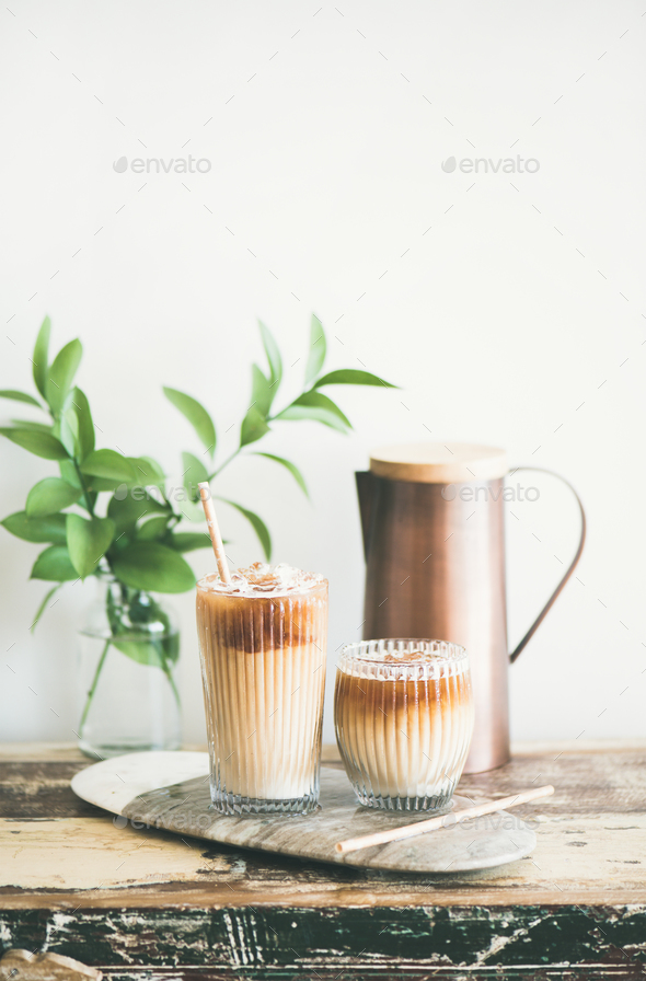 Iced coffee drink in tall glasses with milk, vertical composition Stock Photo by sonyakamoz