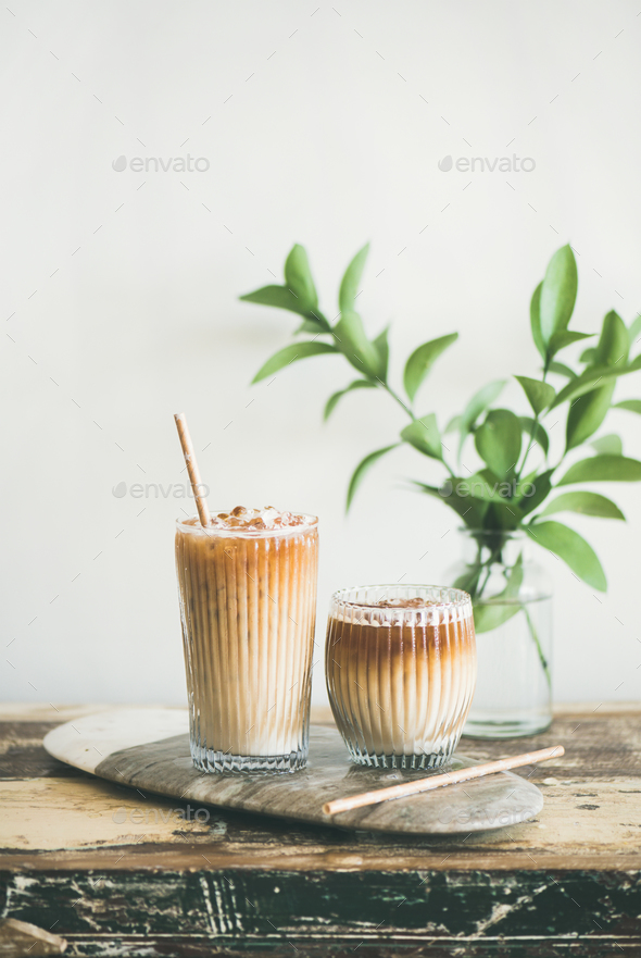 Iced coffee drink in tall glasses with milk and straws - Stock Photo - Images