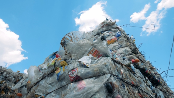 Used Plastic and Polyethylene Compressed and Storaged Outdoors Ready for Recycling. Waste Recycling alt