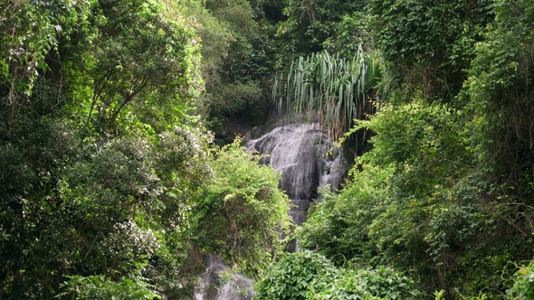 Water Flowing Over Rocky Slope. Tropical Waterfall in Thailand alt