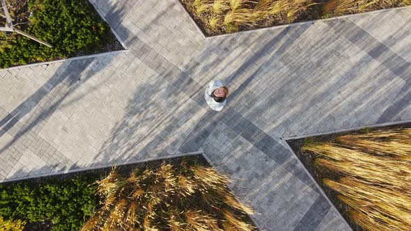 The Man Waves His Hand Towards the Camera alt