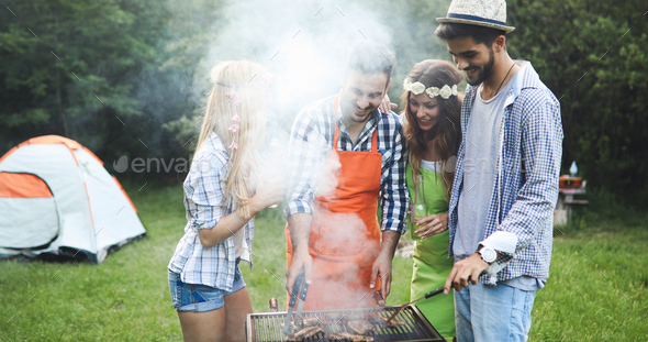 Happy friends enjoying barbecue party Stock Photo by nd3000 | PhotoDune