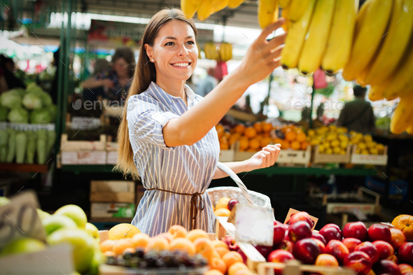 Picture of woman at marketplace buying fruits Stock Photo by nd3000
