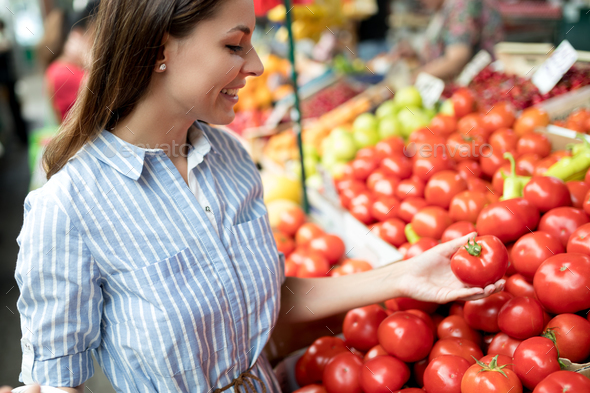 Picture of woman at marketplace buying vegetables Stock Photo by nd3000
