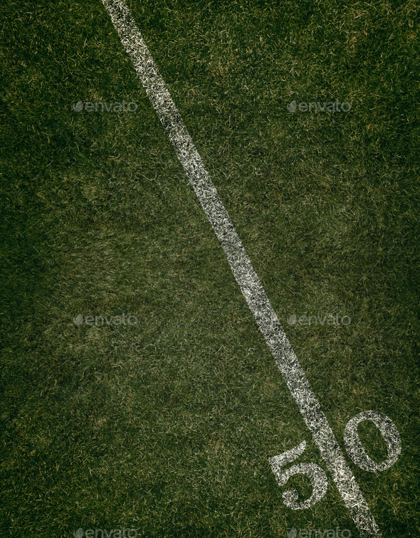 Football field ground fifty yard line. Friday night lights. - Stock Photo - Images
