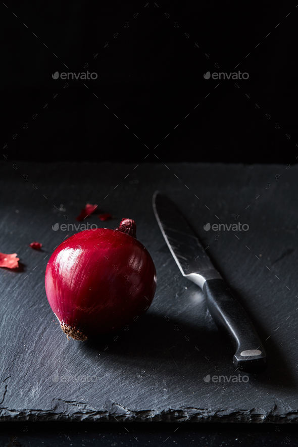 Red spanish onion with kitchen knife on slate backdrop Stock Photo by lenina11only