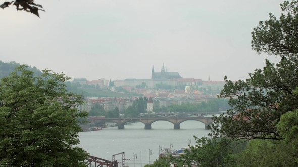 Beautiful View on Prague City, Vltava River and Bridges, Trees Branches Are in Sides