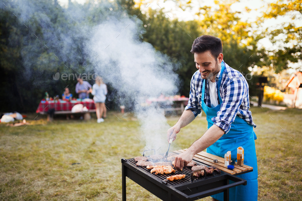 Happy male preparing bbq meat Stock Photo by nd3000 | PhotoDune