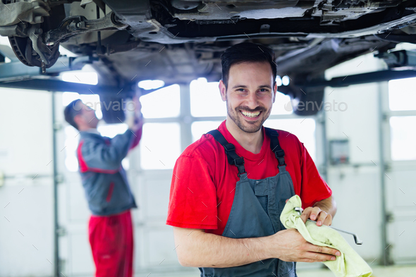Car mechanic working at automotive service center Stock Photo by nd3000