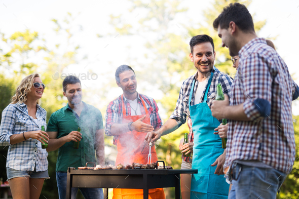 Happy friends enjoying barbecue party Stock Photo by nd3000 | PhotoDune