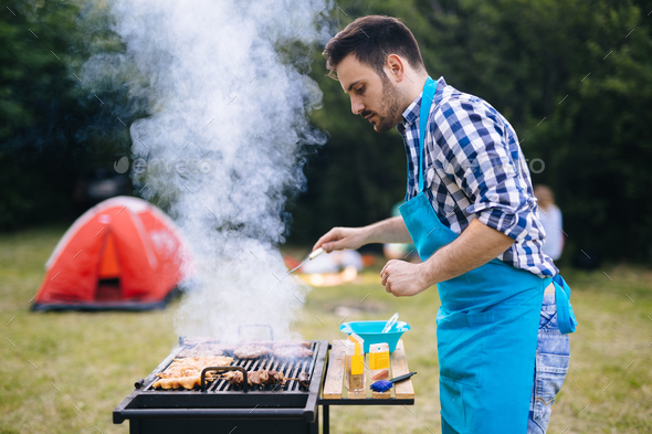 Happy male preparing bbq meat Stock Photo by nd3000 | PhotoDune