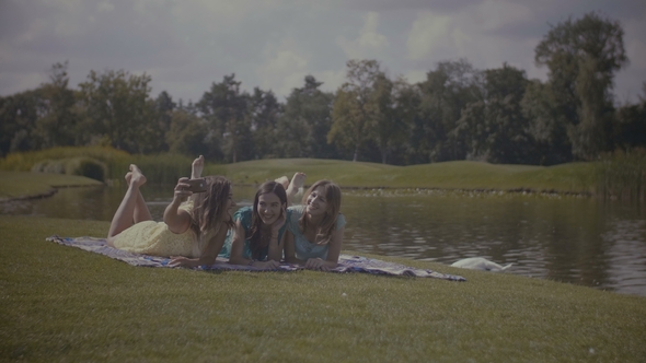 Cheerful Girlfriends Making Self Photo on Cellphone alt