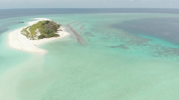 Aerial: Flying over idyllic atoll, travel destination Wakatobi Indonesia alt