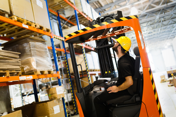 Warehouse worker doing logistics work with forklift loader Stock Photo by nd3000