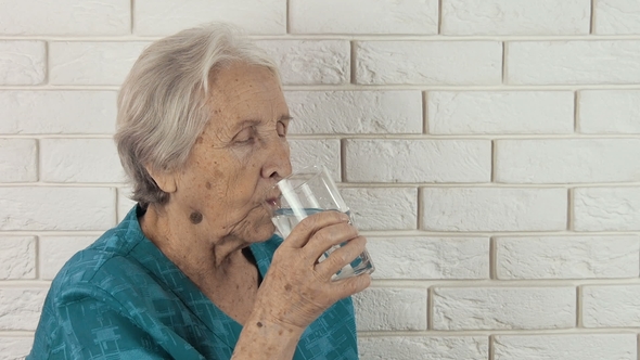 An Elderly Man Drinks Water alt