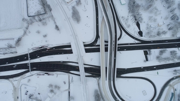 Aerial View of a Freeway Intersection Snow-covered in Winter alt