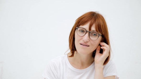 Woman Putting Ear Plugs Into Her Ears Getting Rid on Noise in Loud Place. White Background alt