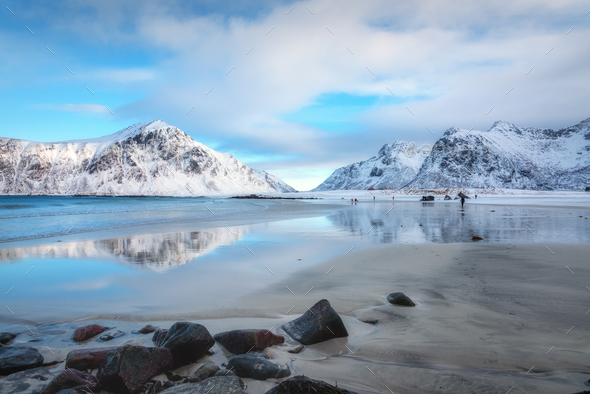 Snowy mountains and blue sky with clouds reflected in water - Stock Photo - Images