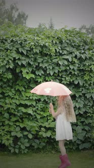 A child under an umbrella jumps