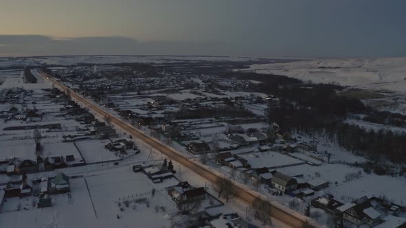 Russian Village in Winter Under a Bright Cloudy Sky