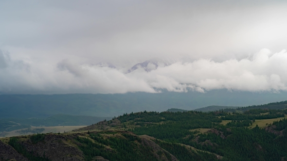 Clouds Cover the Snow-capped Mountains. The Weather Deteriorates, the Mountain Landscape