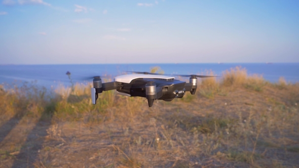 Quadrocopter Decreases and Lands Lands on the Ground. UAV Flight in alt