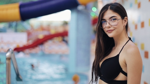 Sexy Young Women in Black Swimsuit Posing in Pool. Portrait of an Attractive Girl in a Water Park or alt