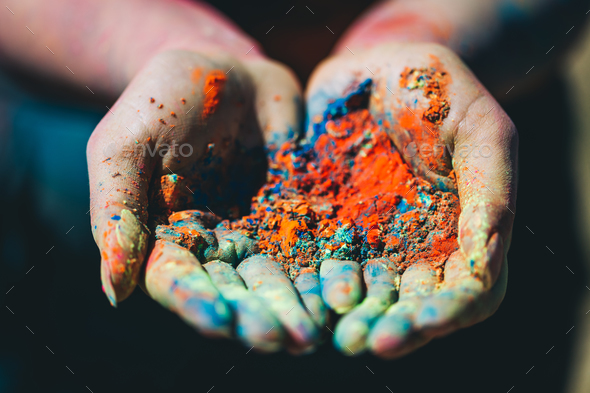 Holi powder held in woman\'s hand. Close-up. Stock Photo by photocreo
