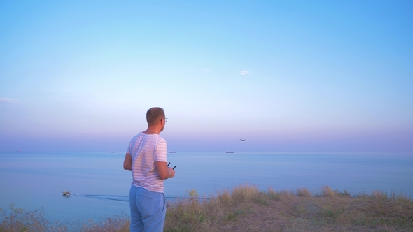 Quadrocopter Flies Over the Man's Head and Lands on His Hand.