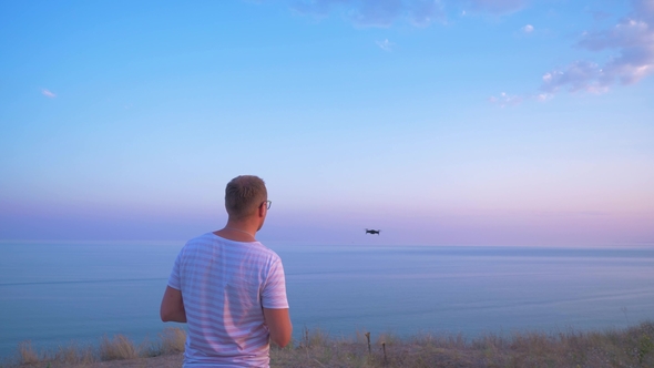 Quadrocopter Flies Over the Man's Head and Lands on His Hand