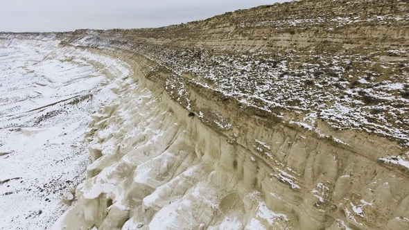 Edge of a Sandy Cliff of the Snow-covered Desert in Winter. Western Kazakhstan, Mangyshlak Peninsula