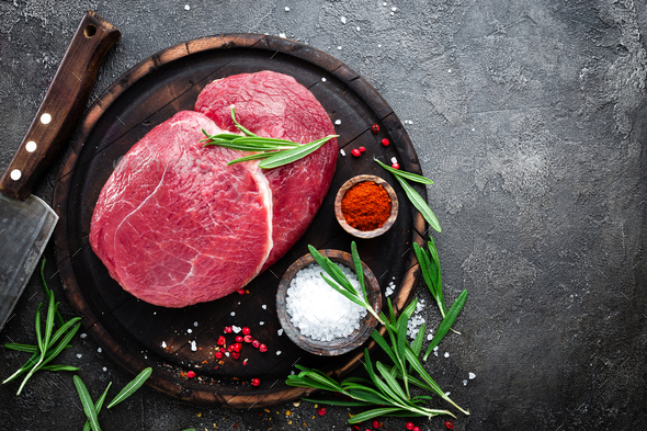 Raw beef meat. Fresh cut of beef meat on board with spices Stock Photo by sea_wave