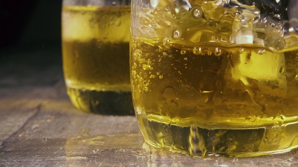 Drops and Ice Cubes in a Glass with an Alcoholic Drink