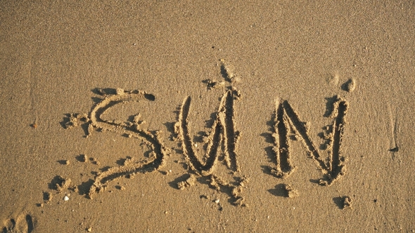 Word "Sun" on the Sand Washed By Waves Video