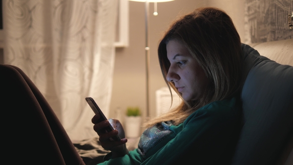Woman Lying In Bed Before Sleep At Home Uses Your Phone Apps