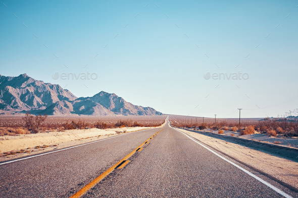 Retro stylized picture of a desert road, USA - Stock Photo - Images