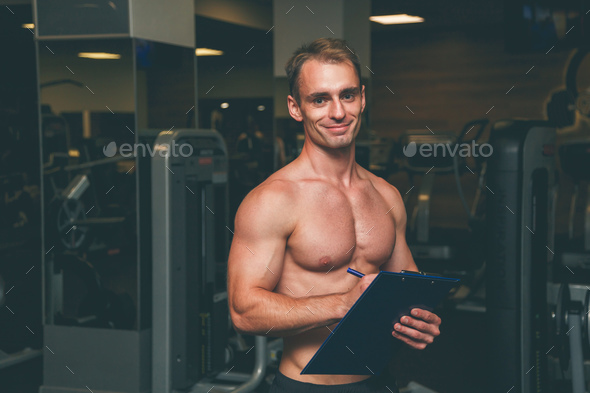 Personal Trainer, with a pad in his hand Stock Photo by Vladdeep | PhotoDune