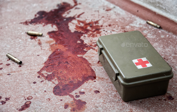 Military firs aid kit on floor with blood stains - Stock Photo - Images