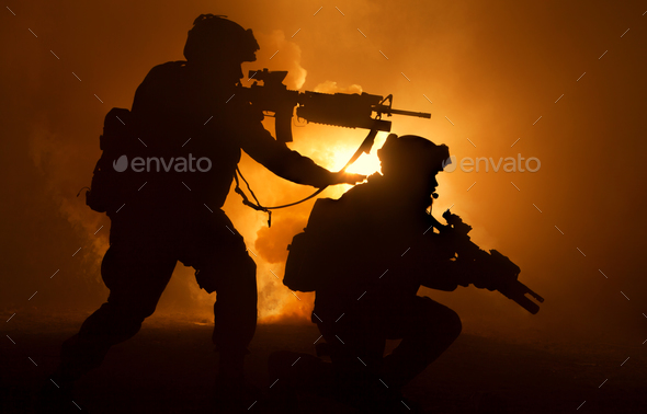 Two attacking soldiers surrounded flame and smoke Stock Photo by Getmilitaryphotos