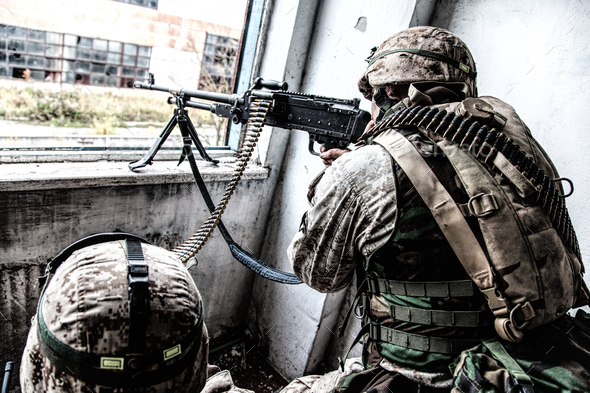 Army machine gunner attacks enemy with aimed fire - Stock Photo - Images