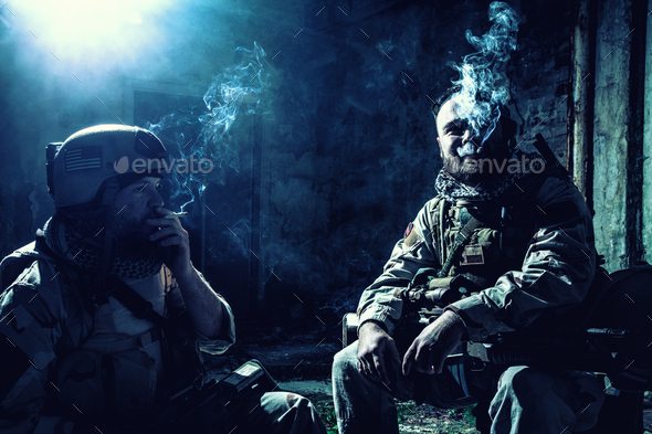 Tired commando soldiers smoking after intensive firefight - Stock Photo - Images